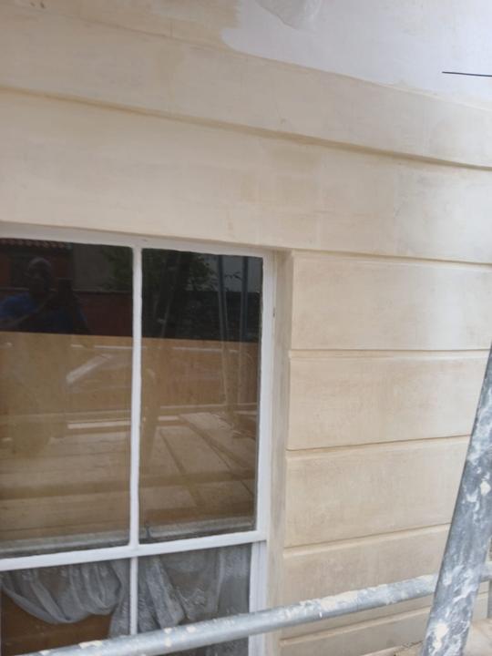 Cleaned ashlar stone around a sash window