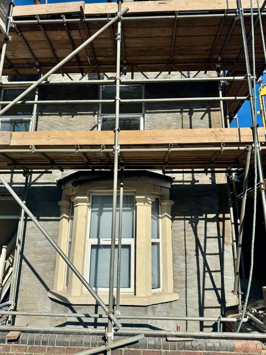 Stone bay window under restoration