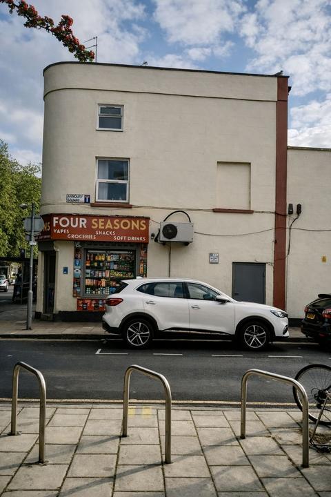 Rendered corner building with curved stair tower