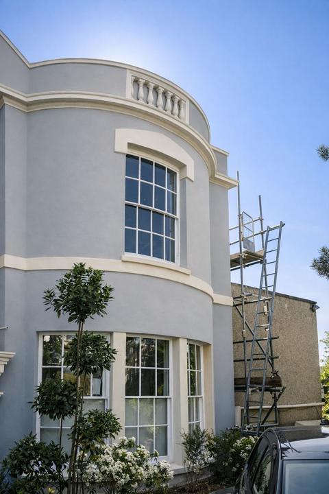 Curved facade with scaffold coming down