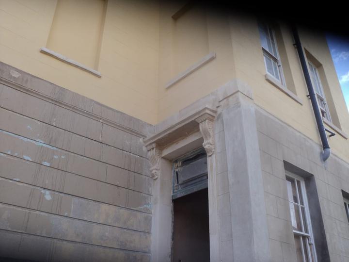 Rusticated stone base and entrance